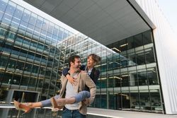 Cheerful couple having fun and hugging on street in downtown