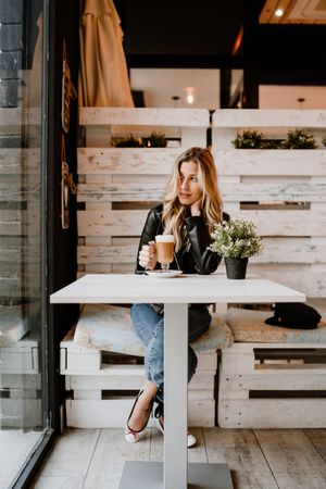 Woman drinking coffee from a glass