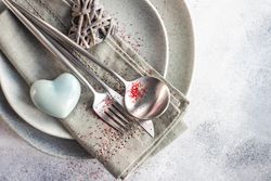 Grey themed table setting for Valentine's day with blue heart