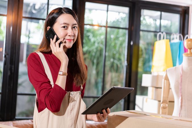 Female e-commerce business owner talking on her phone