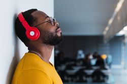 Black man listening to music in headphones