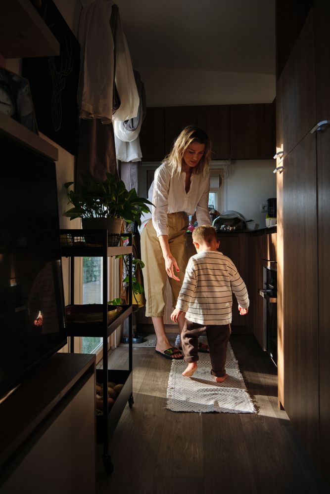 Woman and boy playing in kitchen