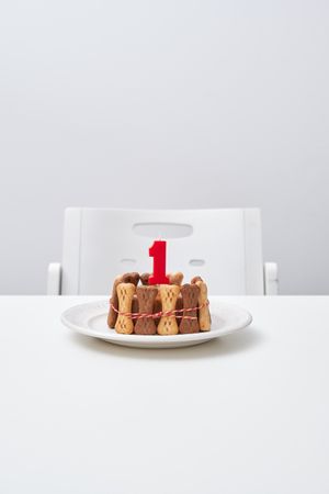 Delicious cake with candle on table