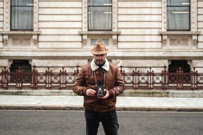 Male tourist walking near old building