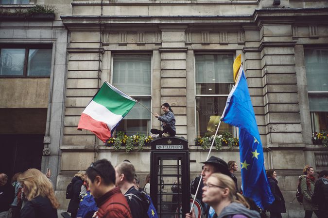 London, England, United Kingdom - March 23rd, 2019: Woman stop phone box with Italian flag