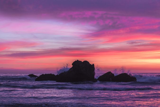 Looking out at rocks in the Pacific Ocean at sunset