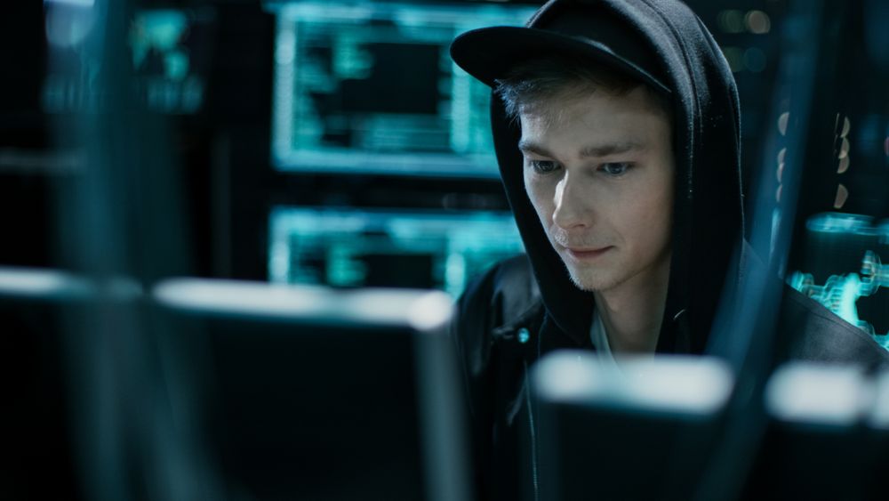 Hooded Hacker Successfully Attacks Global Infrastructure Servers with Virus.