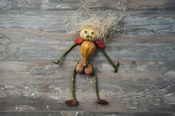 Flat lay of figure made out of vegetables on wooden table