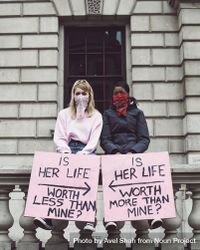 London, England, United Kingdom - June 6th, 2020: Two young women holding opposite signs at protest 0WOzW0