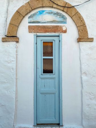 Patmian blue door with archway