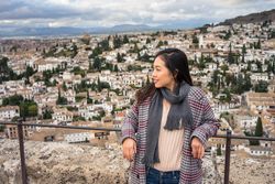 Cheerful woman visiting ancient city
