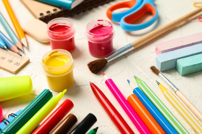 School supplies on white wooden background, closeup