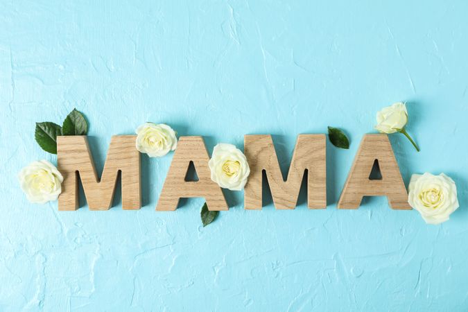 Inscription Mom with roses on color background, space for text