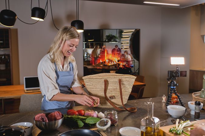 Cheerful woman putting ingredients on table