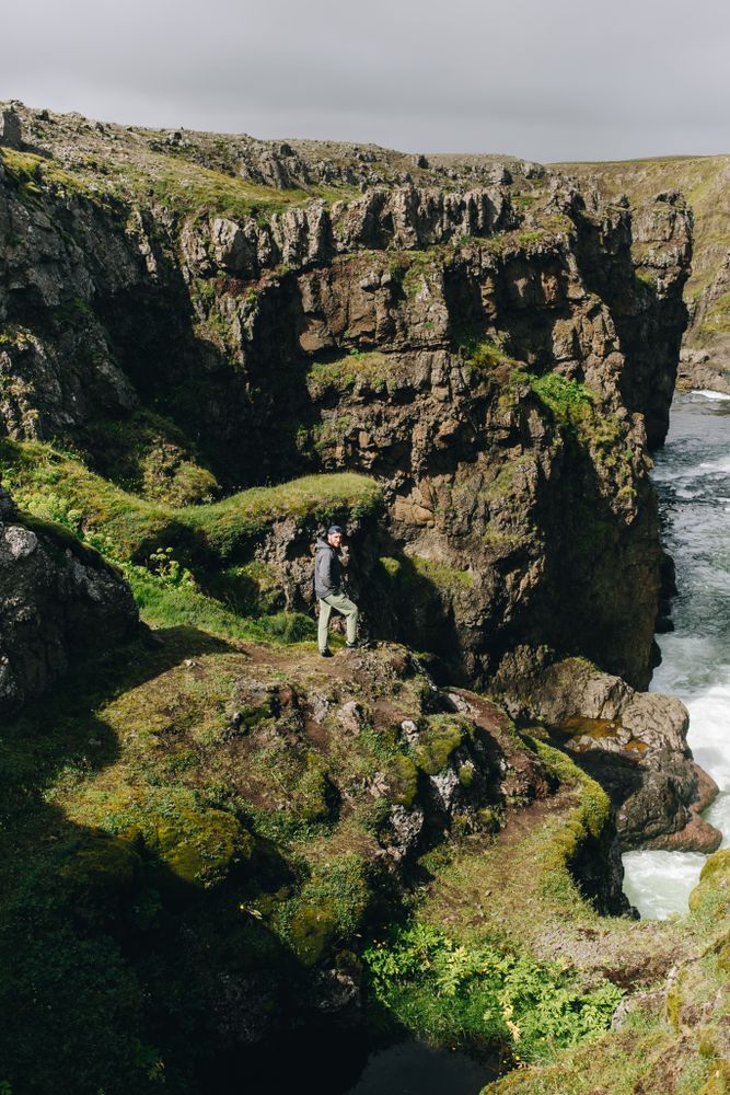 Man looking up from edge of cliff