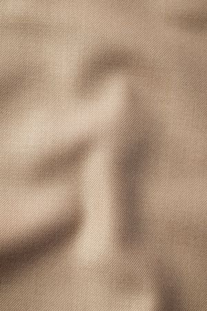 Wavy smooth pattern brown fabric background texture.