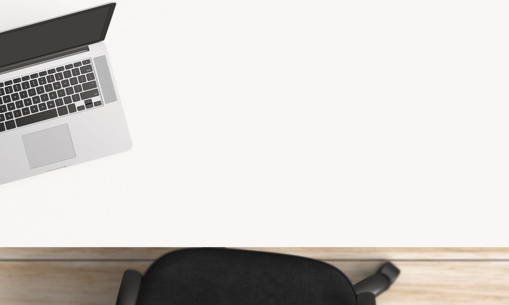 Modern workplace with laptop, coffee cup and notebook copy space on table background. Top view. Flat lay style.
