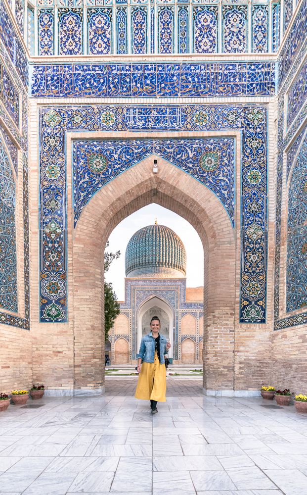 Female tourist in entrance of ornamental building