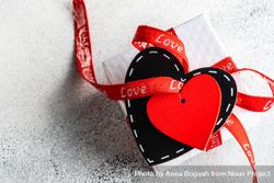 Giftbox wrapped in red ribbon with heart tag 5pggkv