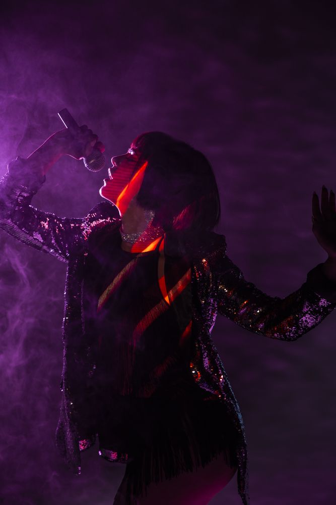 Stylish woman singing on stage