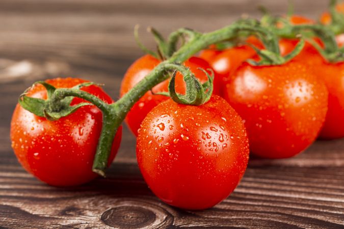 Ripe tomatoes on the wooden table.