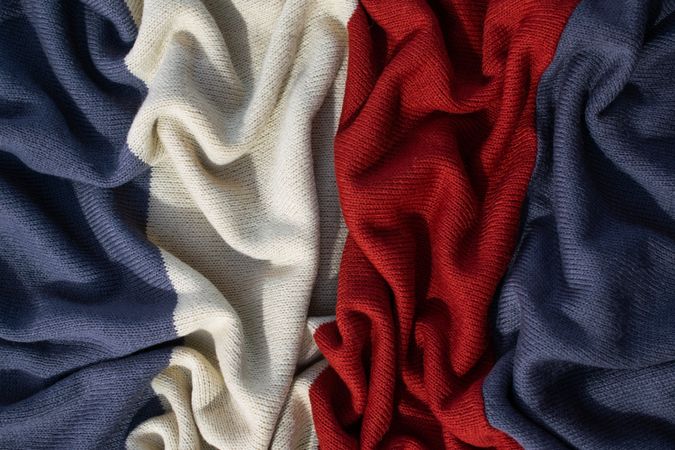 Triple color grey milk and red on knitted fabric wavy crumpled background texture.