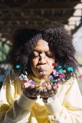 Woman throwing confetti in the air.