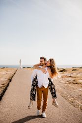 Happy lovers having fun on path from sea
