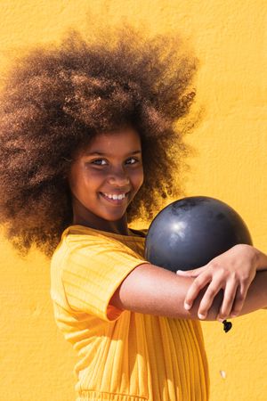 Black girl holding party balloon