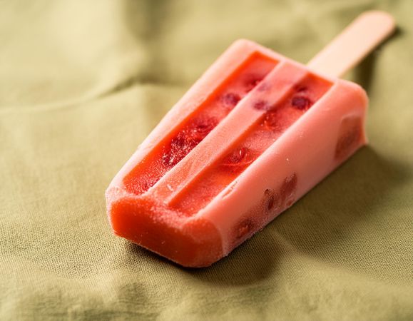 strawberry popsicle on green towel