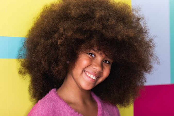 Content Black girl waving hand at camera