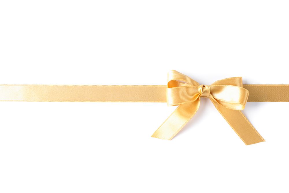 Golden ribbon with bow isolated on blank background. Gift concept
