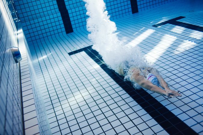 Female swimmer diving underwater