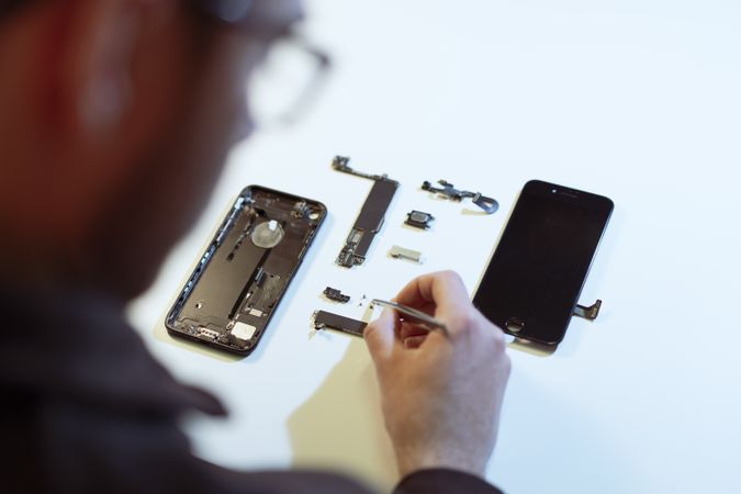 Young man repairing modern device