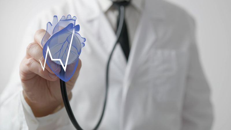 Doctor uses stethoscope with heart hologram