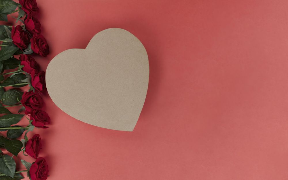 Valentine’s day celebration with red roses and heart shape gift box