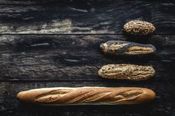 Assorted gold homemade bread on dark wood background