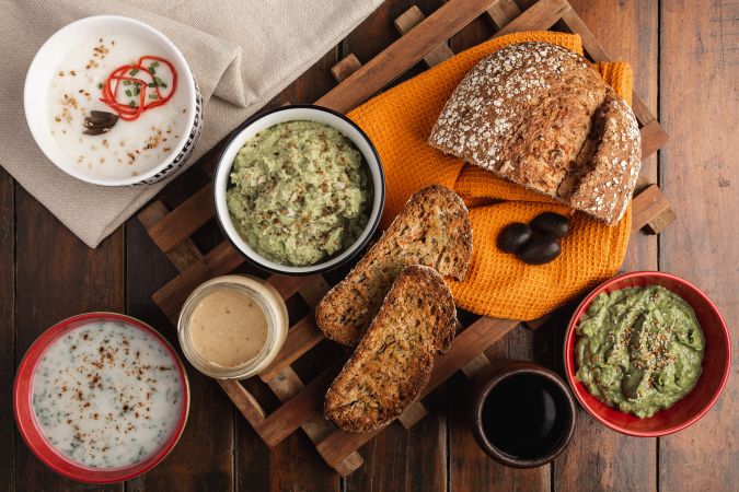 Tasty sauces decorated with sesame seeds and lush bread