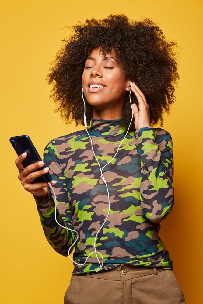 Black woman with smartphone listening music