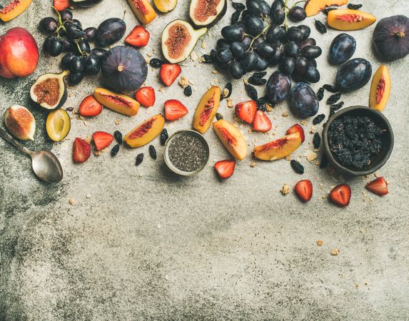 Fruit assortment with figs, grapes, peaches, spoon, chia seeds,  horizontal composition, copy space