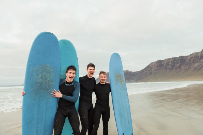Excited men with surfboards