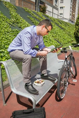 Young business man working with electronic tablet in lunch break