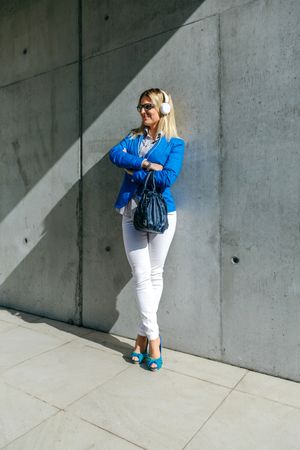Businesswoman with headphones posing