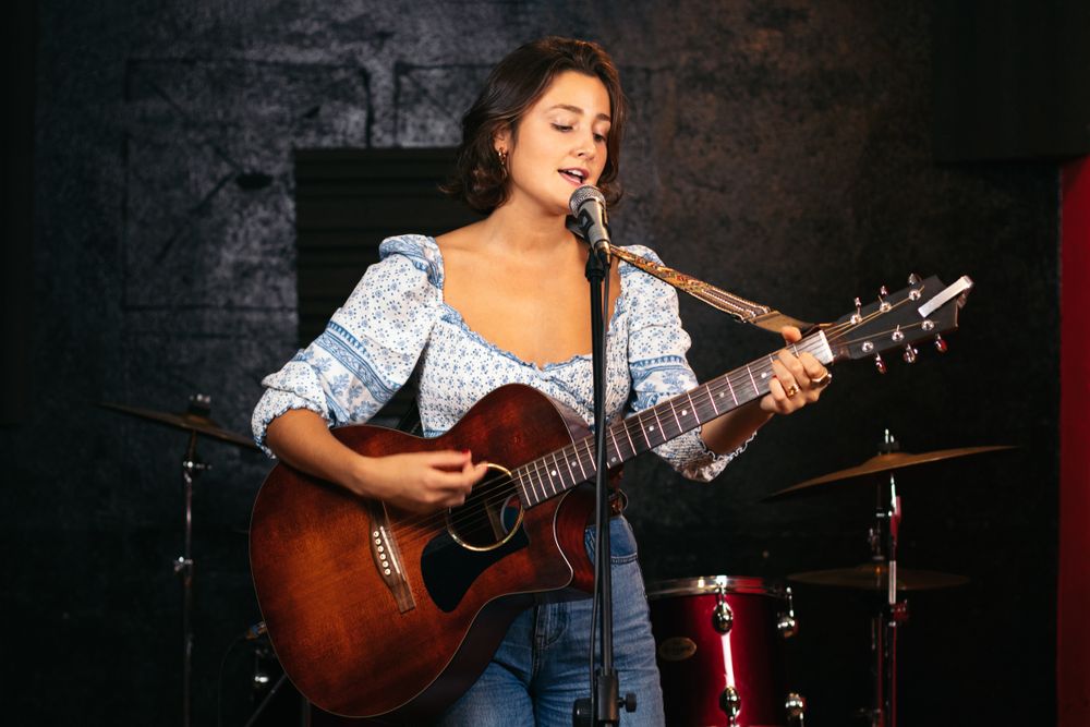 Close-up of a female singer and guitarist rehearsing their songs