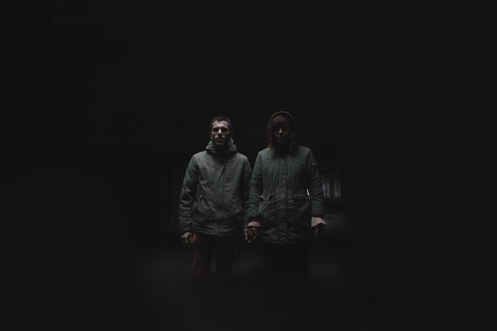 Portrait of a couple. Standing strong in the darkness concept.