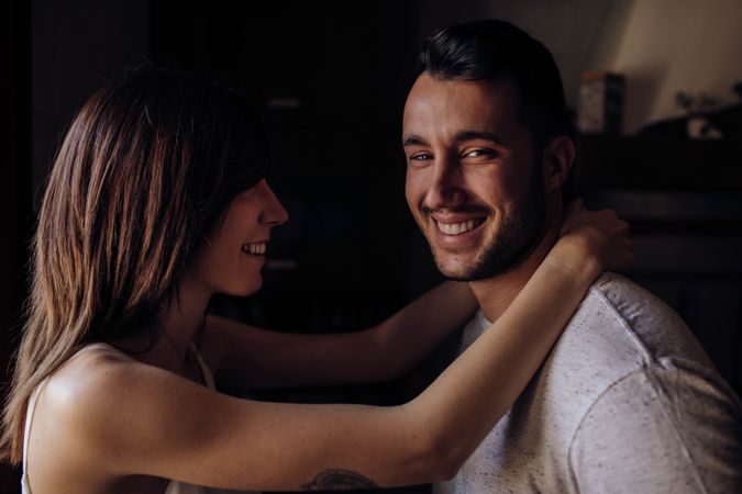 Happy couple sitting on bed