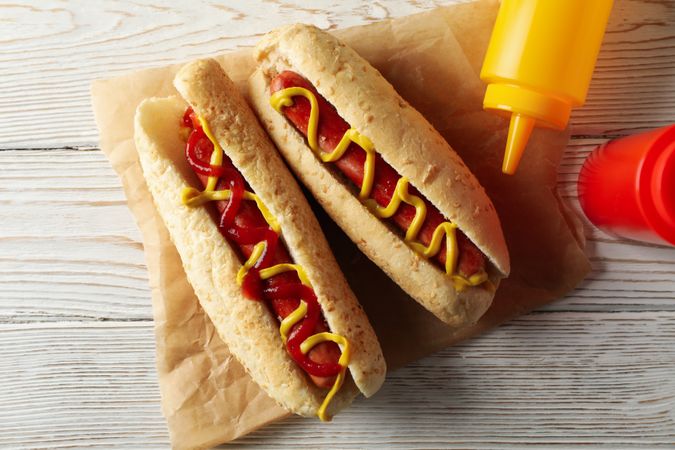 Tasty hot dogs on plain wooden rustic background