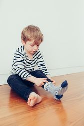 Boy wearing socks on floor