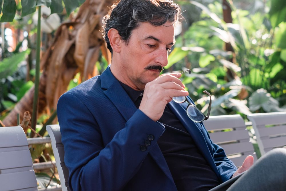 Mature handsome man using digital tablet outdoors