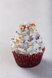 Tasty party cupcakes on the table. Cupcakes with whipped cream.